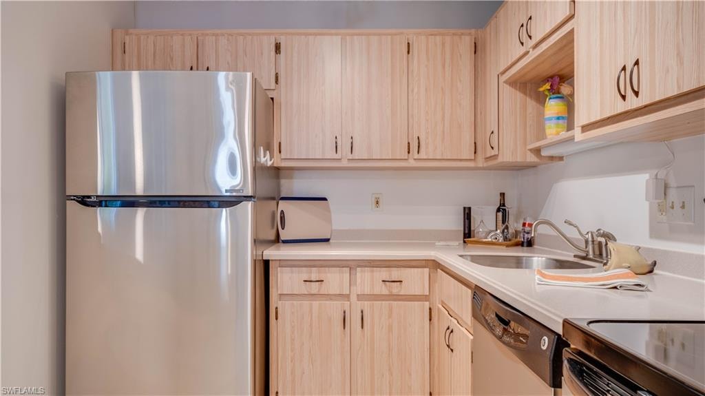 Light toned cabinetry, glistening appliances, and spotless countertops.