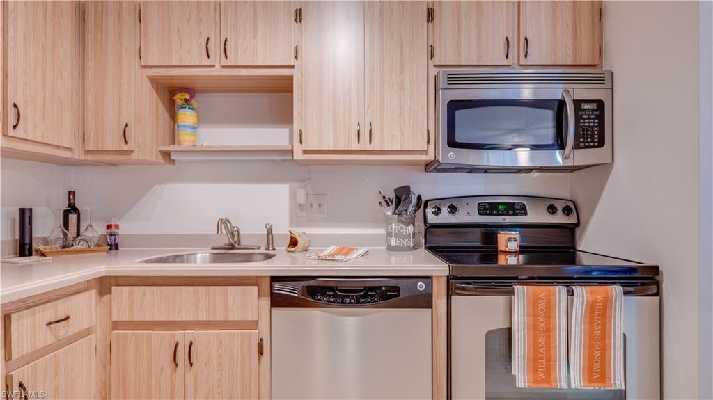 Stainless steel appliances and Corian counters. Cabinetry abounds.