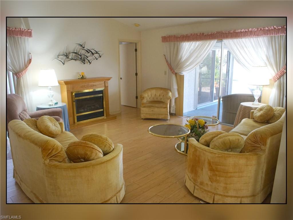 Living area featuring hardwood / wood-style flooring and a glass covered fireplace