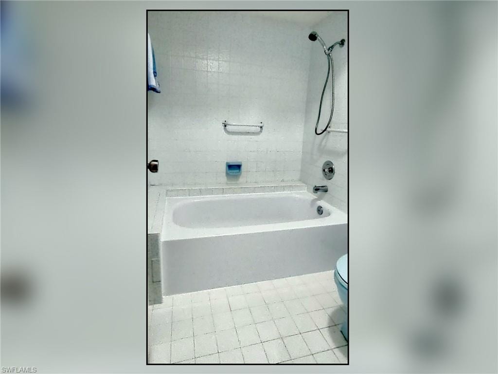 Full bath featuring  shower combination and toilet