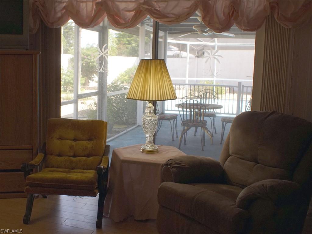 Sitting room featuring plenty of natural light and wood finished floors
