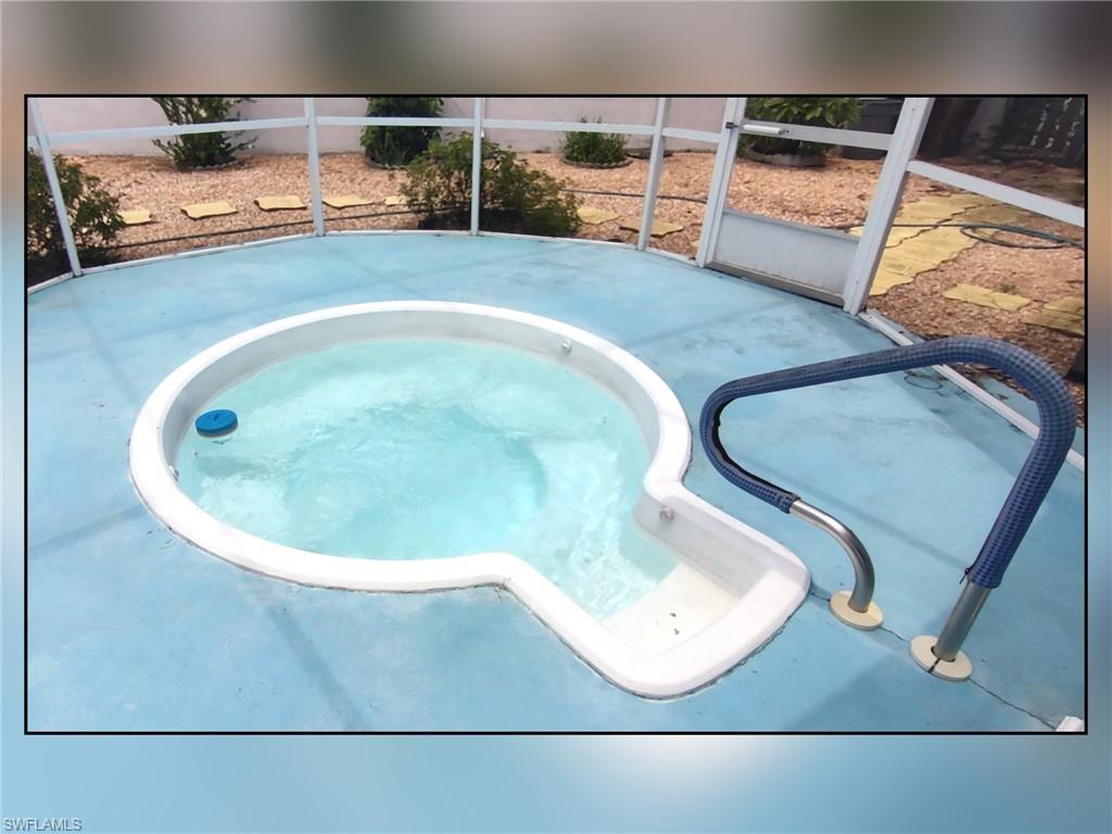 View of swimming pool featuring an in-ground hot tub