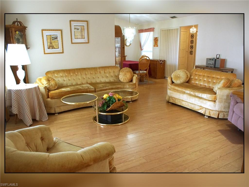 Living area featuring wood-type flooring and a chandelier