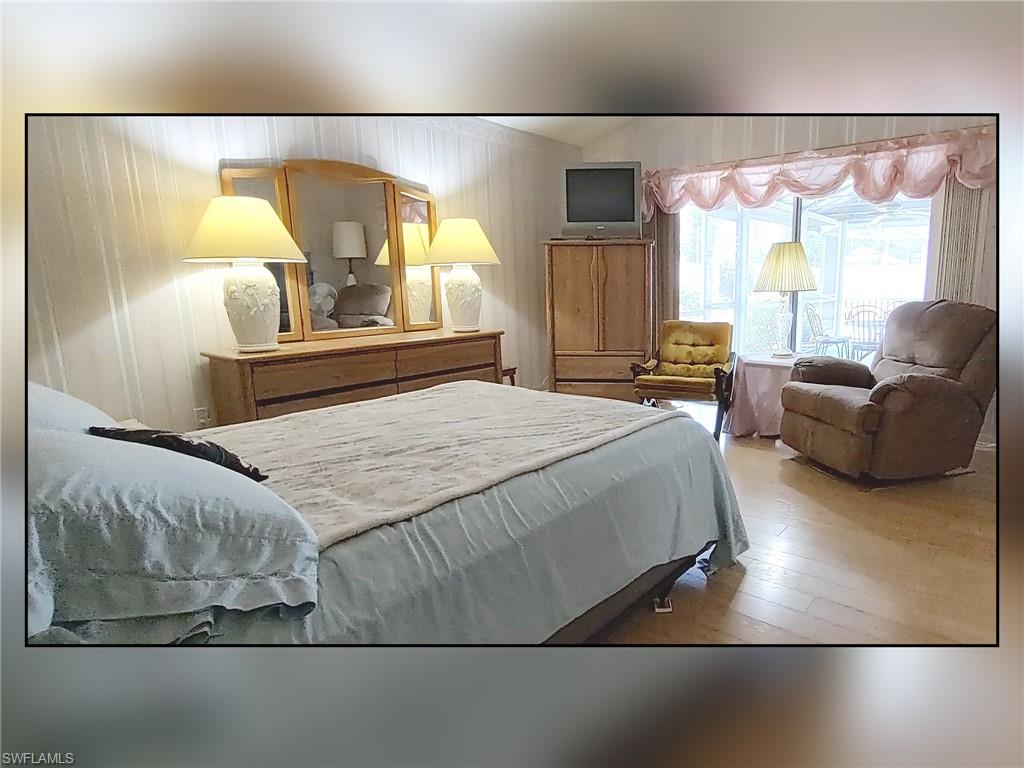 Bedroom with hardwood / wood-style flooring