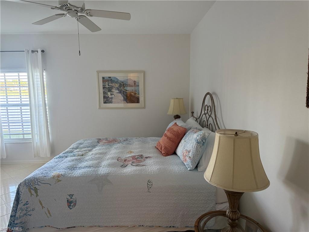 Bedroom featuring a ceiling fan and baseboards