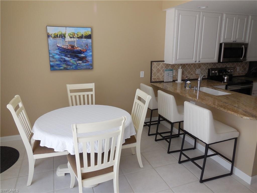 Dining area featuring light tile patterned flooring and baseboards
