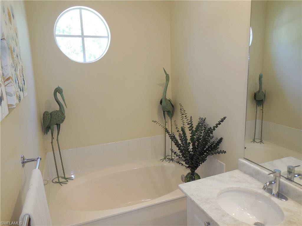 Bathroom with a bath and vanity