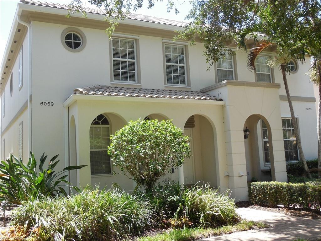 Mediterranean / spanish home featuring a tile roof and stucco siding
