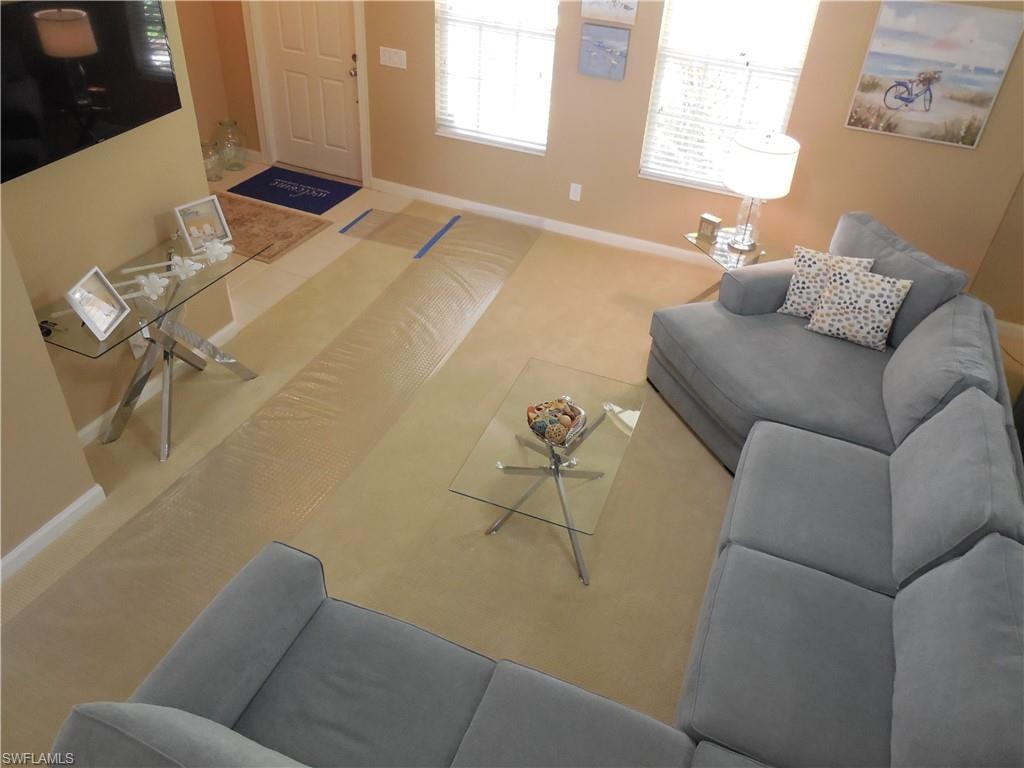 Carpeted living area with baseboards
