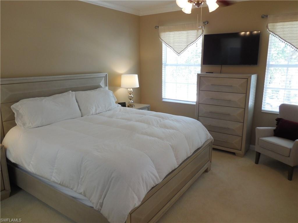 Bedroom featuring crown molding and light colored carpet