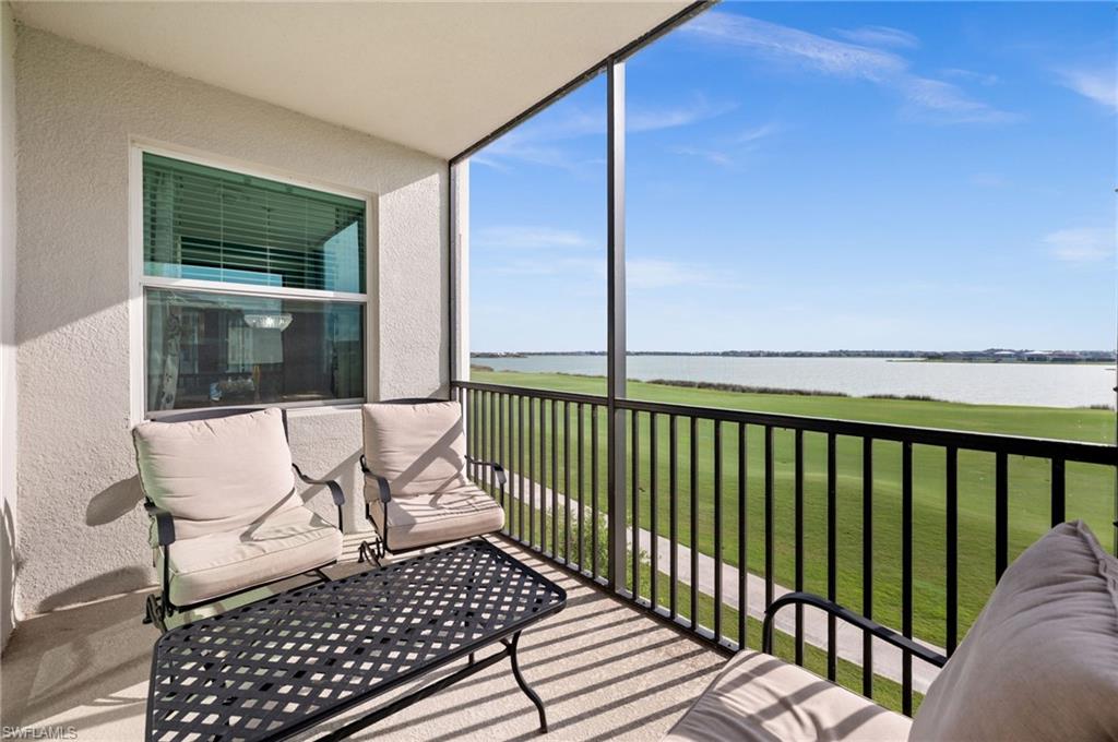 Screened balcony featuring a water backdrop and green space