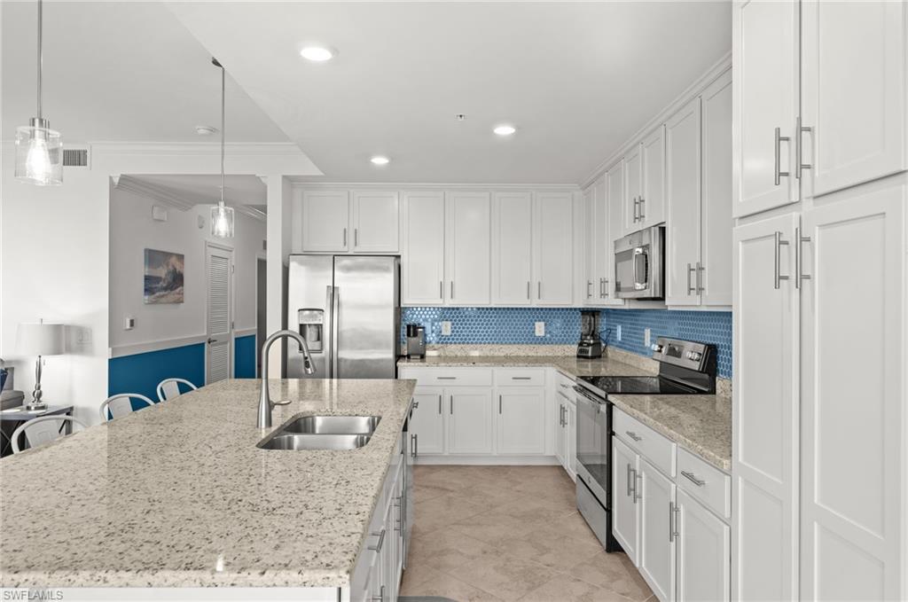 Modern kitchen with white cabinetry and stainless steel appliances