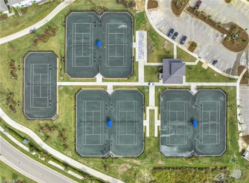Expansive recreational area featuring multiple hard-surface tennis courts