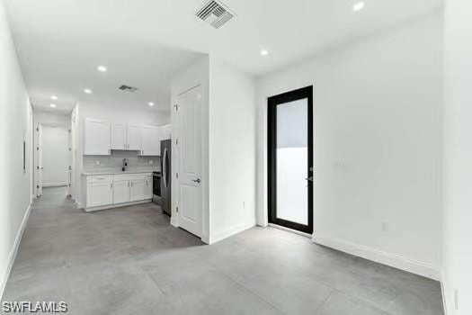 Living room in Second Unit  featuring recessed lighting and concrete floors