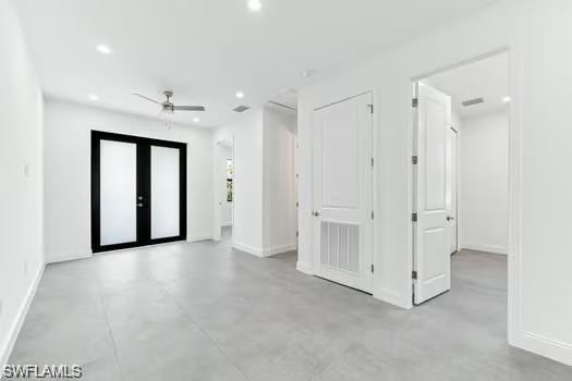 With recessed lighting, concrete flooring, and a ceiling fan