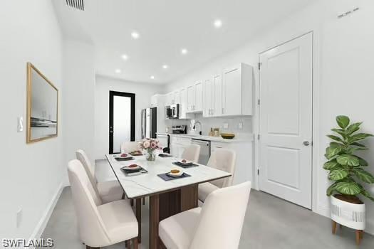 Dining room (Virtual Staged) with recessed lighting and concrete flooring
