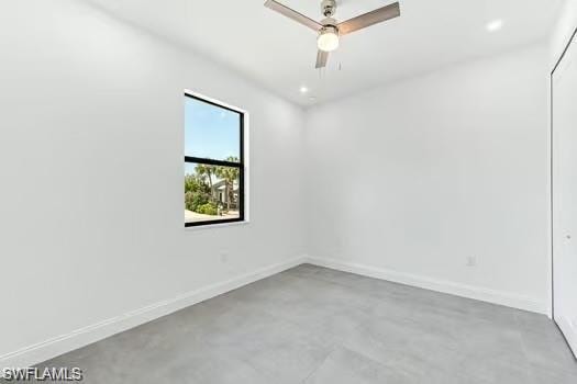 Bedroom on main entrance side with finished concrete floors and a ceiling fan