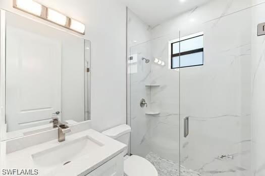 2nd Bathroom in Second Unit with a marble finish shower and vanity