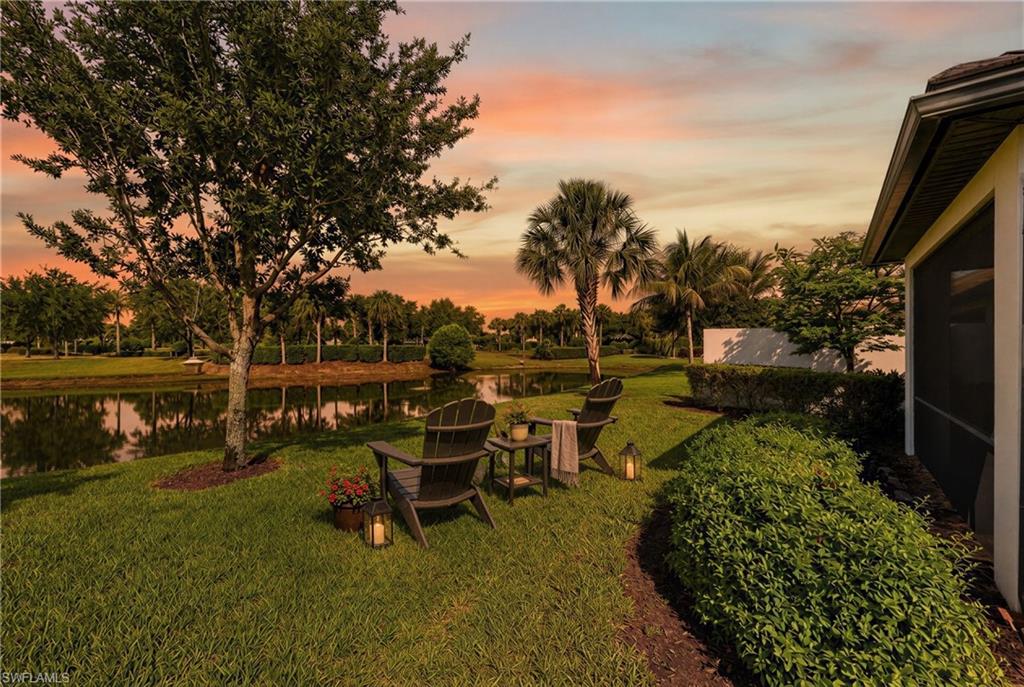 Grassed lawn with a serene pond at the property's edge