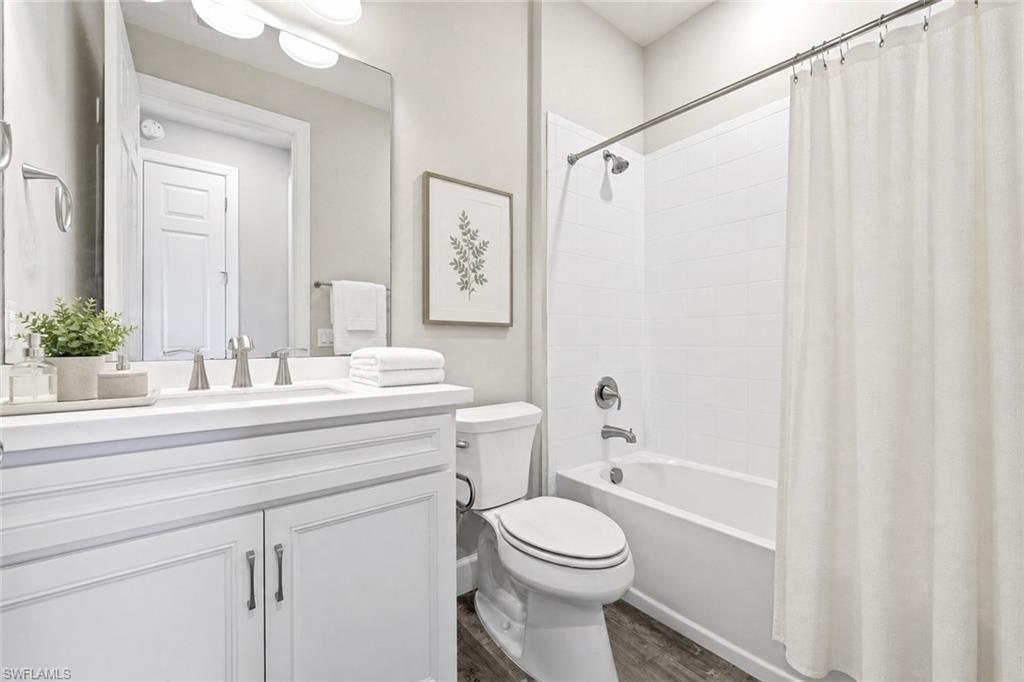 Bathroom featuring a white vanity with brushed nickel hardware, a rectangular sink, and a white countertop
