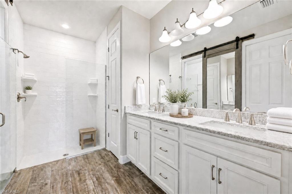 Dual vanity with light-toned countertop, undermount sinks, and brushed nickel fixtures