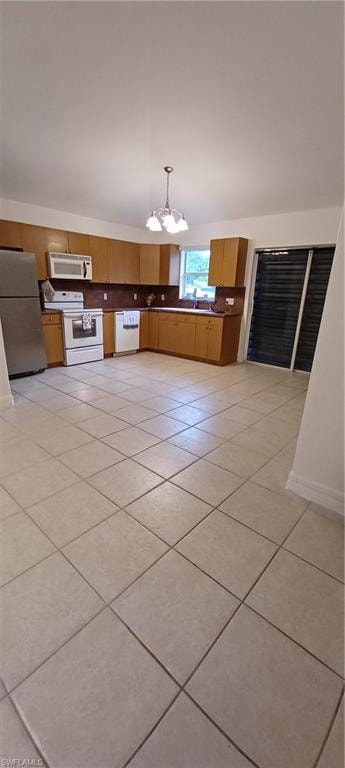 Kitchen with tile flooring, wood cabinetry, and stainless steel appliances
