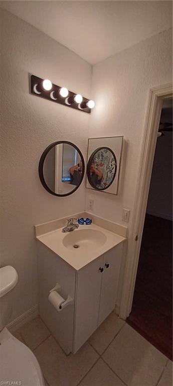 Master Compact bathroom featuring a Corner Vanity with integrated sink, chrome faucet, and white cabinetry