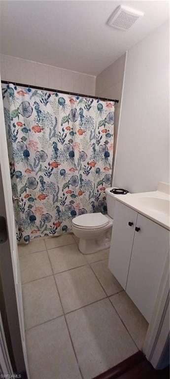 Master Bathroom featuring a white vanity with integrated sink, a toilet, and tiled flooring