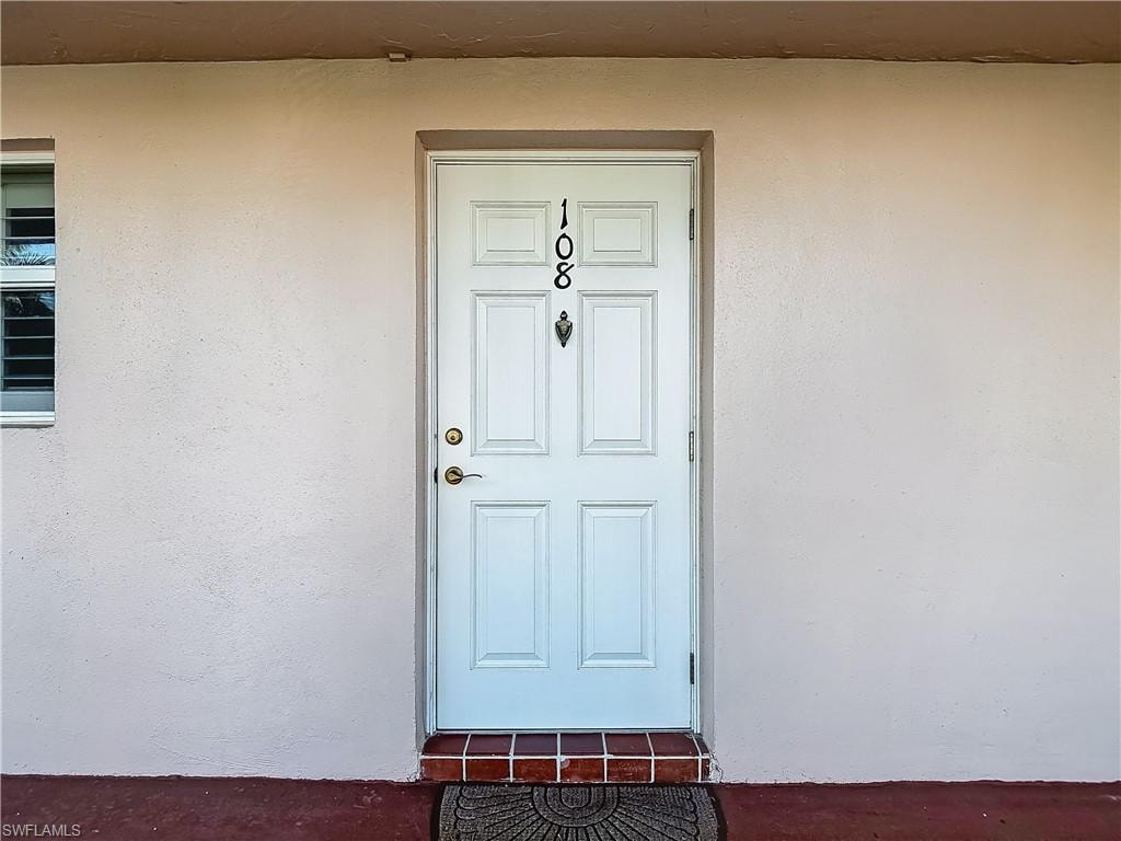 Property entrance featuring stucco siding