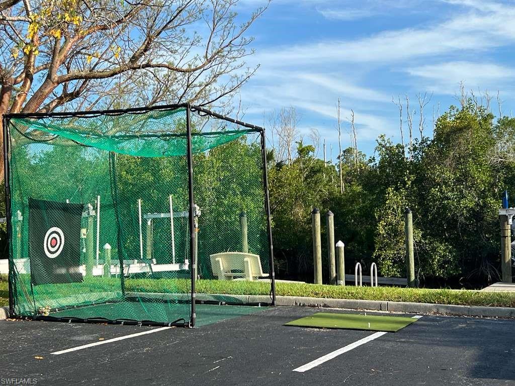Outdoor golf practice net with artificial turf hitting mat