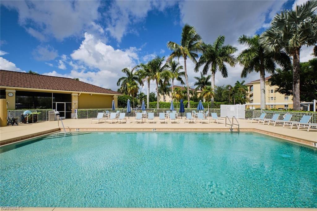 Rectangular swimming pool with integrated steps, surrounded by a paved deck