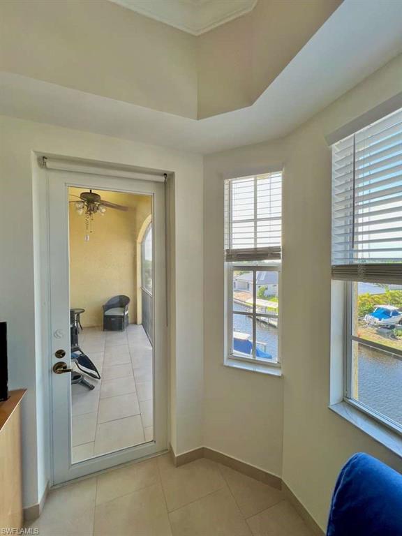 Tray ceiling detail, glass-paneled door, and multiple windows offering canal views