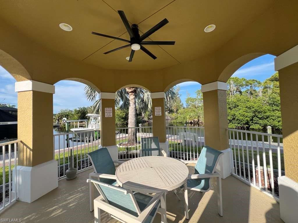 Covered patio featuring an arched design and a ceiling fan with integrated lighting