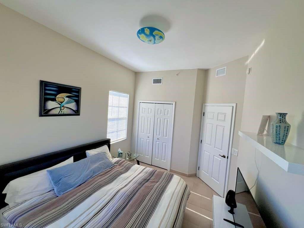 Interior room featuring light-toned walls and tile flooring