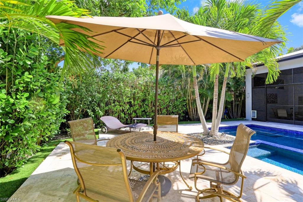 View of patio with a pool with connected hot tub