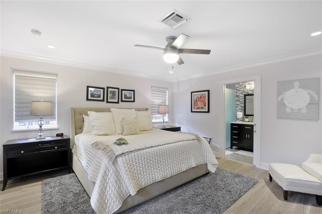 Bedroom featuring ornamental molding, light wood-style floors, ceiling fan, connected bathroom, and recessed lighting