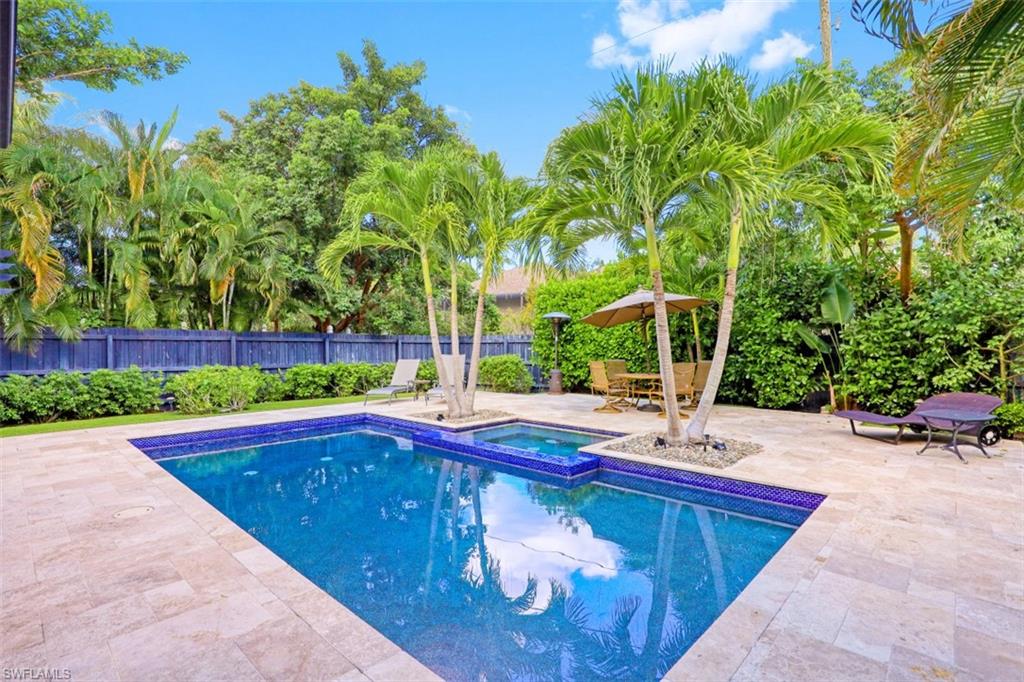 View of pool featuring an in-ground hot tub, a fenced backyard, and a patio