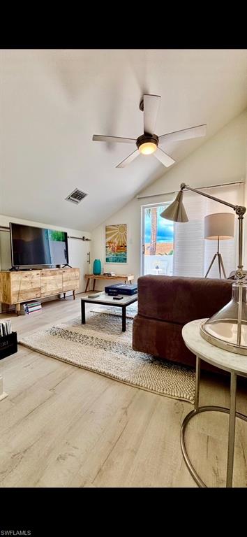 Vaulted ceiling featuring a ceiling fan with integrated lighting