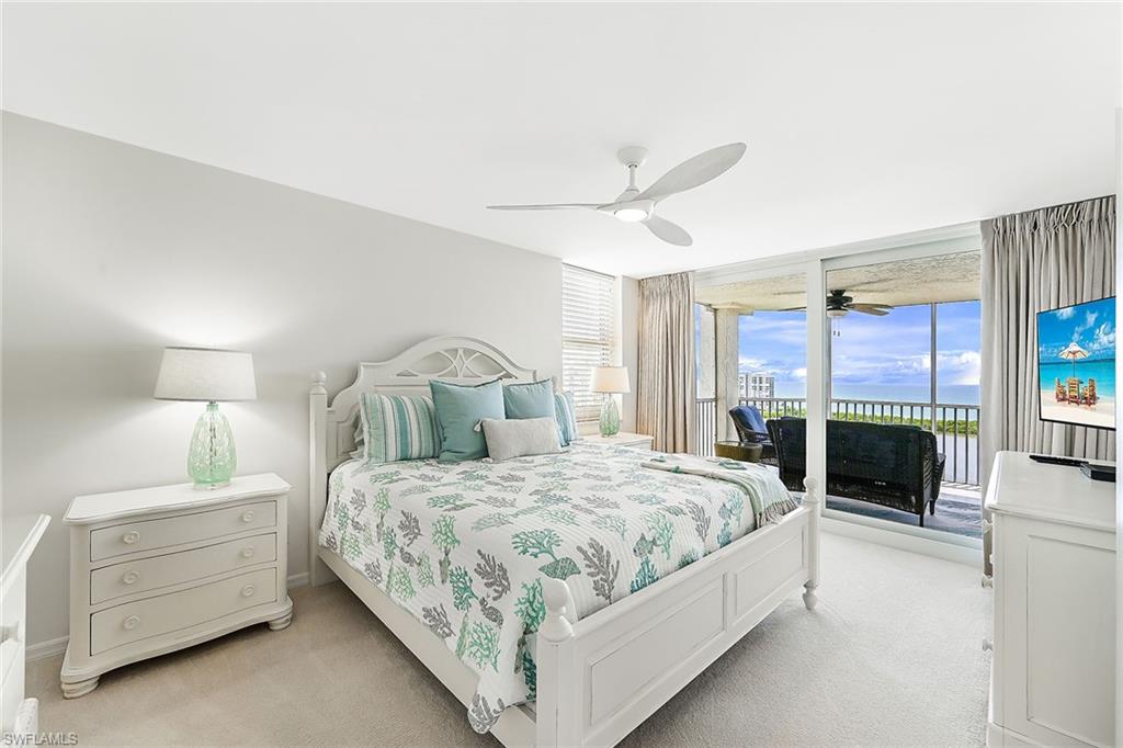 King bed in Primary Bedroom/ sliders open to screened patio