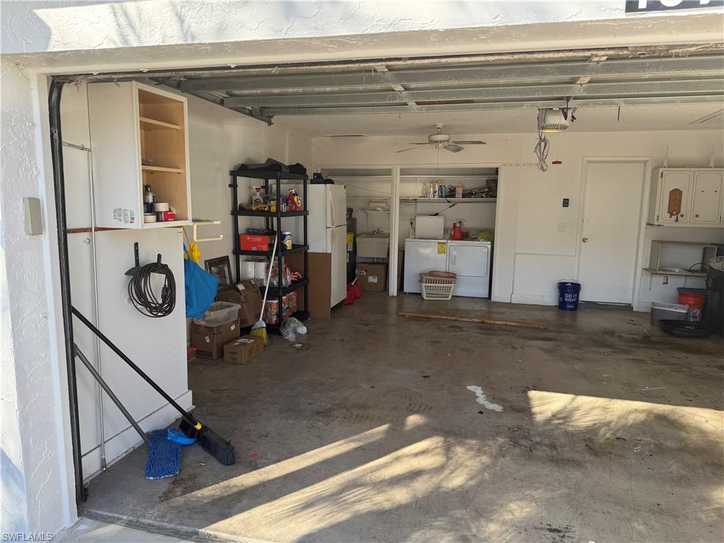 Garage featuring washer and dryer