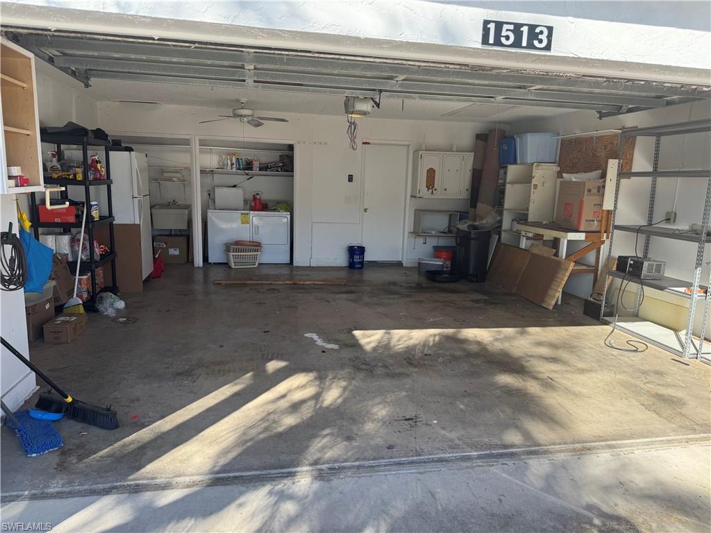 Garage featuring washing machine and dryer and a sink