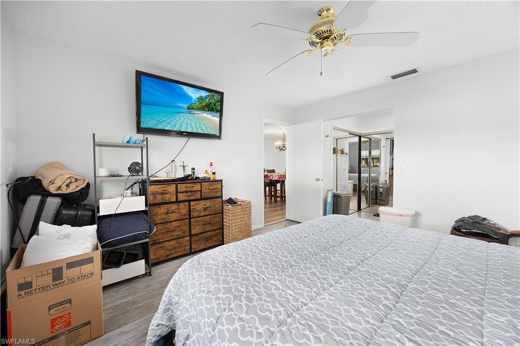 Bedroom featuring a closet, wood finished floors, and ceiling fan