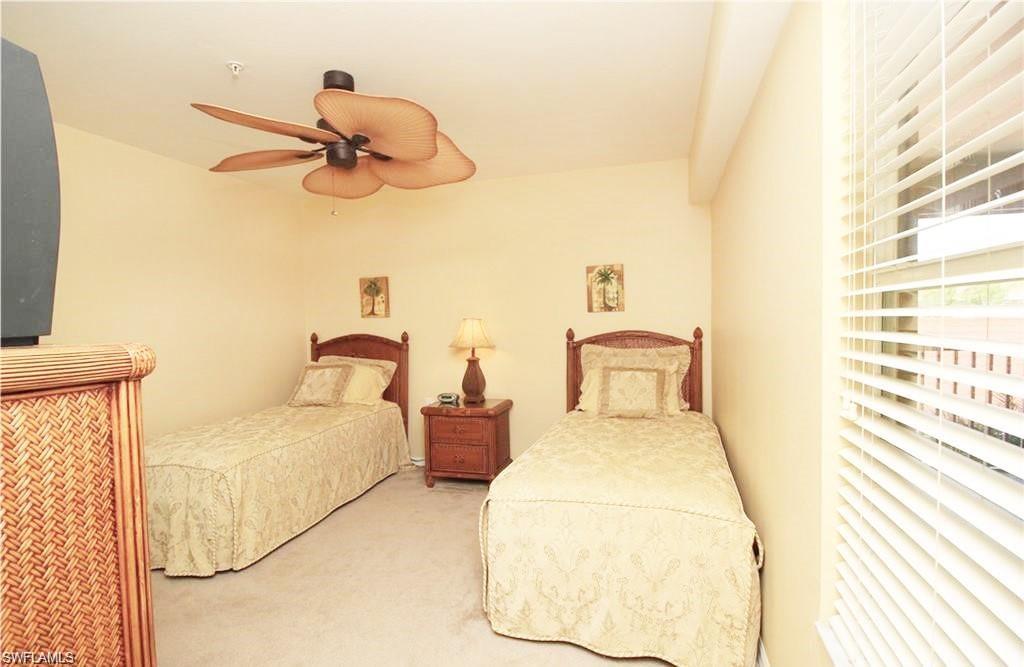 Carpeted bedroom with ceiling fan