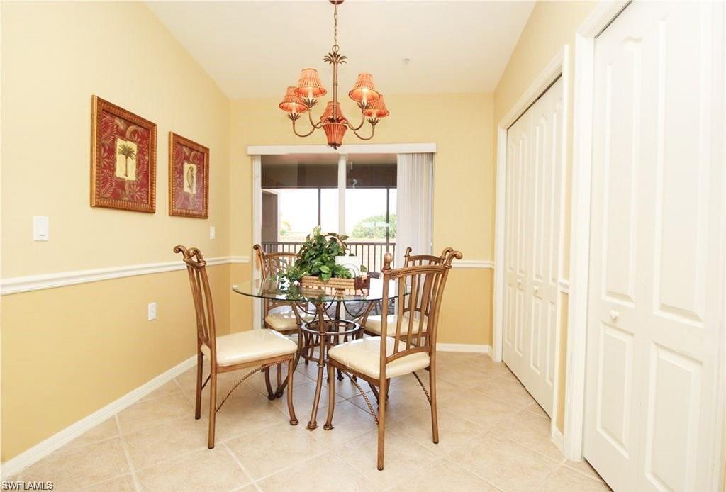 Tiled dining room with a chandelier