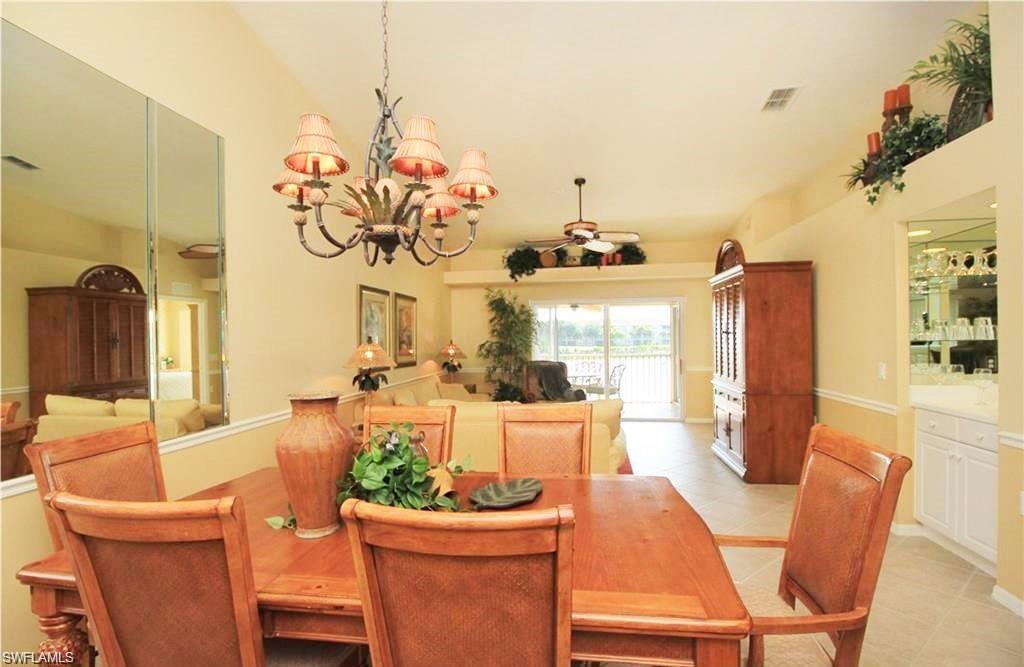Dining area featuring light tile patterned floors and an inviting chandelier
