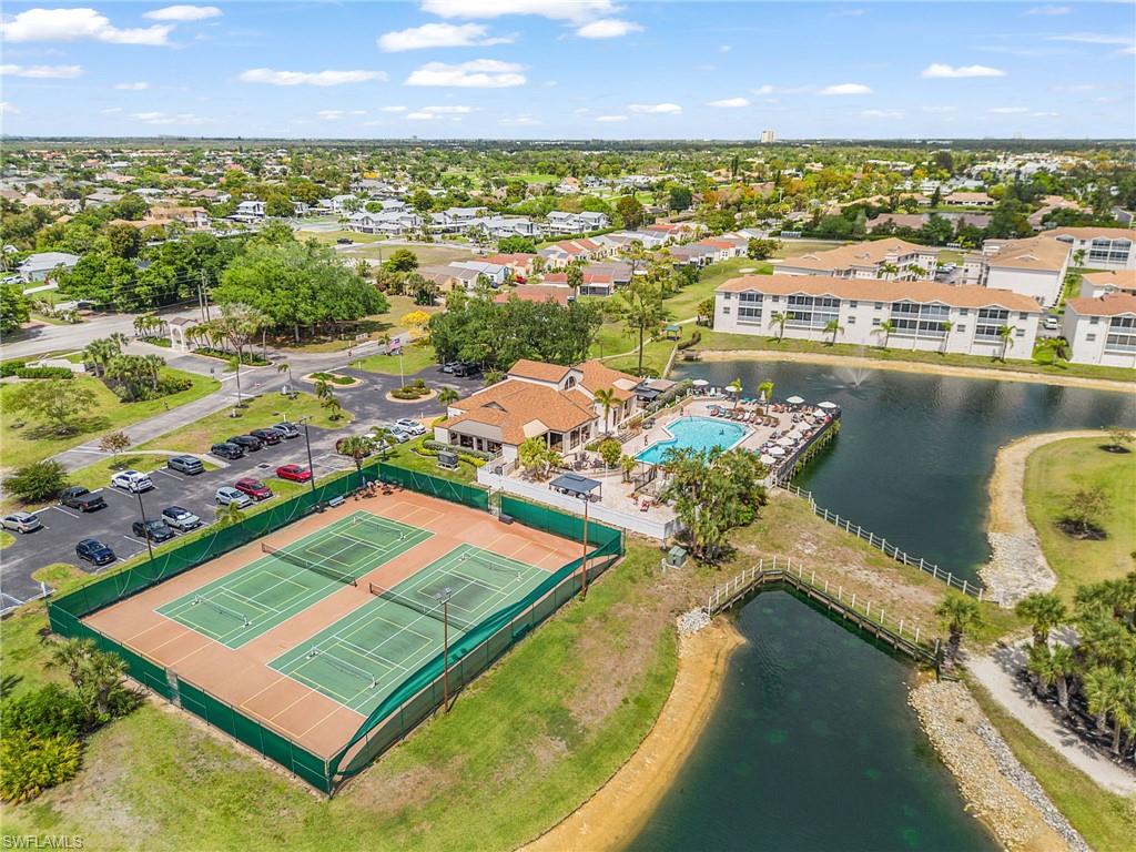 Community amenities featuring tennis courts, a clubhouse with a pool