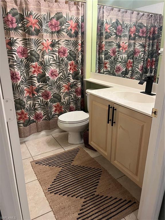 Guest bathroom vanity featuring basin sink and a matte black faucet