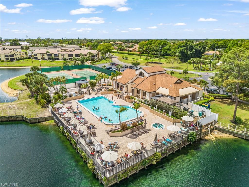 Community recreational building with a large outdoor pool, accompanying spa,
