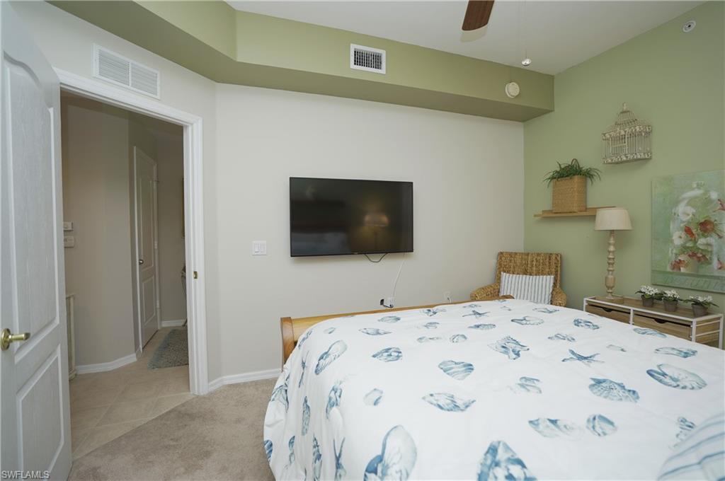 Bedroom with light colored carpet and ceiling fan