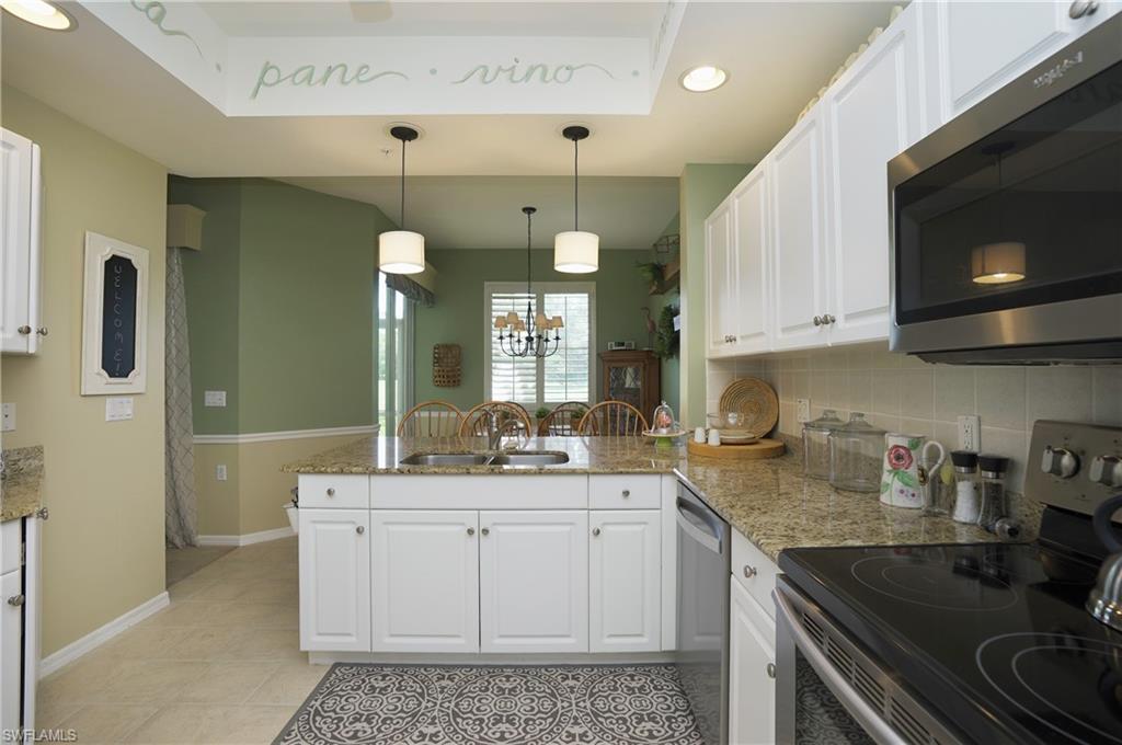Kitchen featuring appliances with stainless steel finishes and white cabinetry